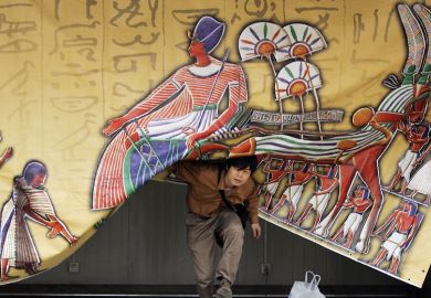 Person appears from under a  curtain in Beijing Person appears from under a an Egypt- theme curtain in Beijing to illustrate Asia tipped to follow US lead with open access mandates