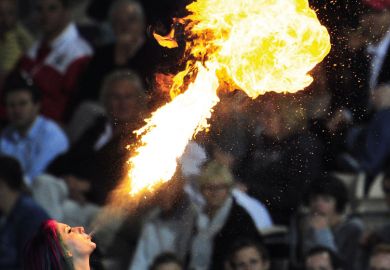 A fire-eater entertains the crowd to illustrate Australian international education blows hot and cold