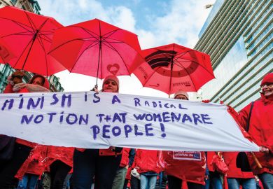 A group of women are holding a feminist placard while holding red umbrellas, during the National demonstration for better social security, in Brussels  A group of women are holding a feminist placard while holding red umbrellas, during the National demonstration for better social security, in Brussels