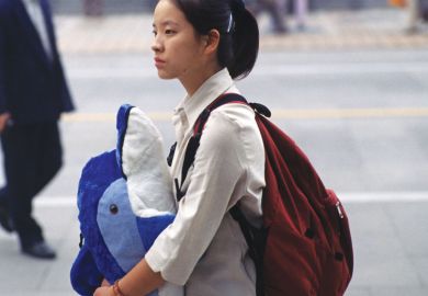 Chinese lady holding toy whale Chinese lady holding toy whale