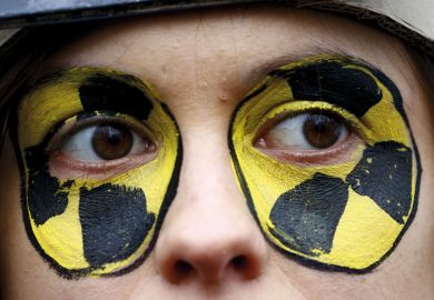 Close up of face with eyes painted circles yellow and black 