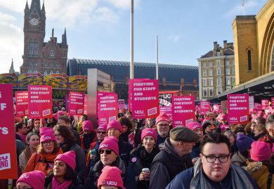 Protesters hold UCU strike placards during a rally to illustrate Pay must be sustainable for institutions rich and poor, v-cs say