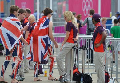 People wearing UK flag outfits walk through gates to illustrate Student number controls for England ‘still under discussion’