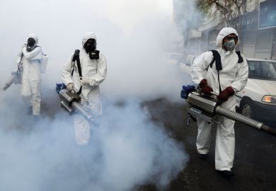  Fire brigade crews wearing protective masks carry out disinfection works in Tehran, Iran to illustrate Iran forces regime critics out of academia