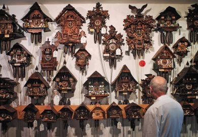 A man looks at cuckoo clocks A man looks at cuckoo clocks to illustrate Quality questions as publisher’s growth challenges big players