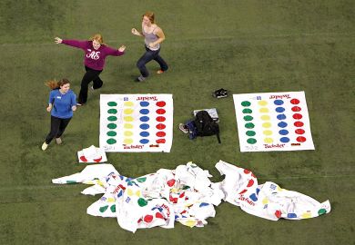 Volunteers run around prior to a failed attempt to break the World Twister record in Toronto, Ontario, Canada. Volunteers run around prior to a failed attempt to break the World Twister record