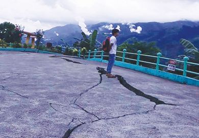 Person stands next to cracks in the ground at a park in Leyte province, central Philippines Person stands next to cracks in the ground at a park in Leyte province, central Philippines as a metaphor for the pan-regional university risks being split by the same tensions