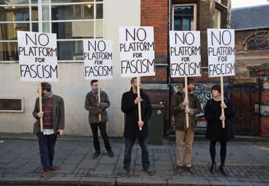 Protesters gather outside Cambridge University's Student Union holding banners reading 'No platform for fascism'