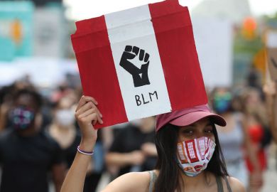 Protester holds  Black Lives Matter banner Protester holds  Black Lives Matter banner