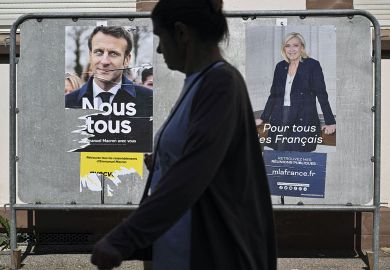 A pedestrian walks past campaign posters of French President and La Republique en Marche (LREM) party candidate for re-election Emmanuel Macron (L) and French far-right party Rassemblement National (RN) presidential candidate Marine Le Pen in Mulhouse A pedestrian walks past campaign posters of French President and La Republique en Marche (LREM) party candidate for re-election Emmanuel Macron (L) and French far-right party Rassemblement National (RN) presidential candidate Marine Le Pen in Mulhouse