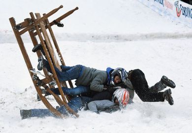 Participants of a sledge race fall in Garmisch-Partenkirchen, southern Germany to illustrate EU drops limit on fixed-term contracts but sector concerns remain