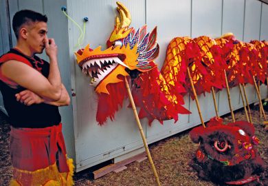 A dancer stands next to a dragon held up with poles in Buenos Aires, Argentina to illustrate Fees for foreign students ‘a sign of what’s to come’ in Argentina