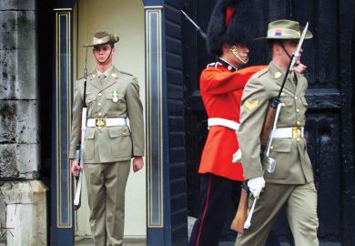 An Australia's Federation Guard mans the sentry box with two other guards marching away.jpg A member of Australia's Federation Guard mans the sentry box with two other guards marching away, one also an Australia's Federation Guard the other a British Grenadier Guard, as a metaphor for Australian institutions changing guard.