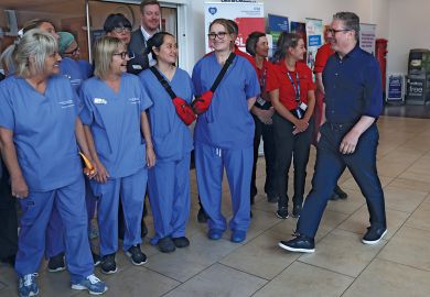 Leader of the Labour Party Keir Starmer prepares to pose with NHS staff in Bassetlaw Hospital Nottinghamshire to illustrate Universities ready to meet Labour’s demand for more key workers