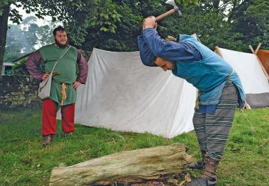 Members of the Barbarian camp chop firewood as the lives of Roman Legionnaires are re-enacted in the UK to illustrate More than 100 research posts at risk at Sheffield nuclear centre