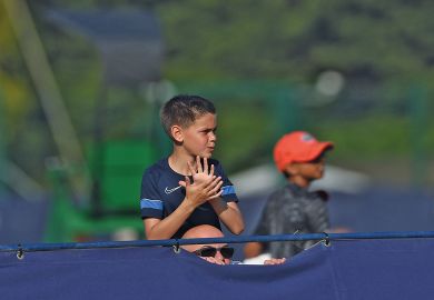 A tennis fan watches a game on his father shoulders over the fence n Surbiton, England A tennis fan watches a game on his father shoulders over the fence n Surbiton, England to illustrate Reverse visa crackdown for ‘brightest and best’, says LBS dean