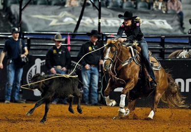 Person competes in the breakaway roping event during The American Rodeo, Texas Person competes in the breakaway roping event during The American Rodeo, Texas to illustrate How Walmart founders’ donation bankrolled US private school push