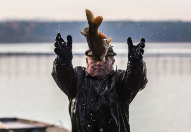  A fisherman catching a big fish to illustrate Delaware ecologist caught in fish research misconduct net