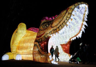 A giant illuminated sculpture of a creature with it's mouth open and people walking inside A giant illuminated sculpture of a creature with it's mouth open and people walking inside to illustrate It’s ‘feast or be eaten’ for France’s booming private HE sector