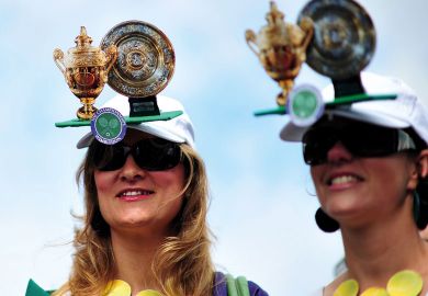 Tennis fans wear hats featuring the cups during the Wimbledon Tennis Championships to illustrate Royal Society offers publishing discounts for peer reviewers
