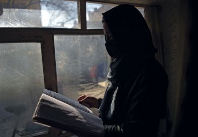 Marwa, a student at her home in Kabul reading next to a window as women are now banned from attending university in Taliban Marwa, a student at her home in Kabul reading next to a window as women are now banned from attending university in Taliban