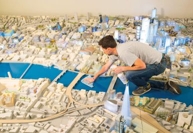 Person cleans the City of London's official 1:500th scale architectural model of central London Person cleans the City of London's official 1:500th scale architectural model of central London to illustrate Is a federated model universities’ future?