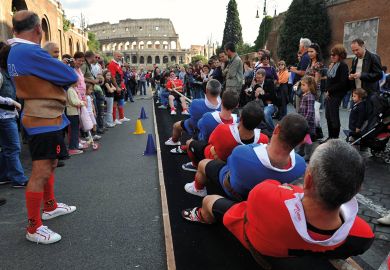 Traditional tug-of-war game near the ancient Colosseum in Rome Traditional tug-of-war game near the ancient Colosseum in Rome to illustrate Italy mandates live delivery and staff ratios for online degrees