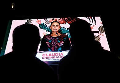 Supporters of Mexico's presidential candidate for Morena party Claudia Sheinbaum look at her on a screen Supporters of Mexico's presidential candidate for Morena party Claudia Sheinbaum look at her on a screen to illustrate Mexican scholars hope for change as scientist takes presidency