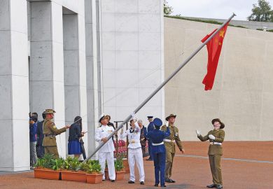 Australian soldiers lower a Chinese flag to get it untangled outside the Parliament House in Canberra to illustrate Chinese students ‘turned off Australia’ by visa crackdown