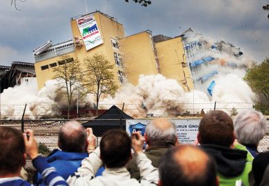 Residents watch a  controlled demolition in the Netherlands Residents watch a  controlled demolition in the Netherlands to illustrate Overseas student caps in limbo after Dutch government collapses
