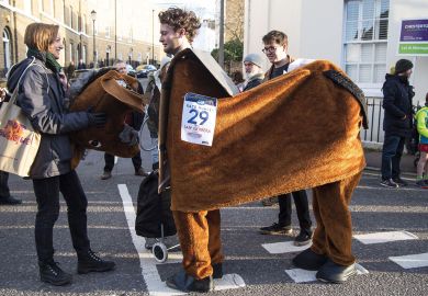 Person holds the horse costume head in the annual pantomime horse race to illustrate Academics hatch plan to save disbanded research centre