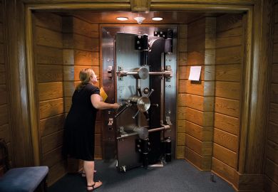 Person opens the library's vault located in the basement of the Folger Shakespeare Library, Washington to illustrate US universities protest against research fraud transparency rules