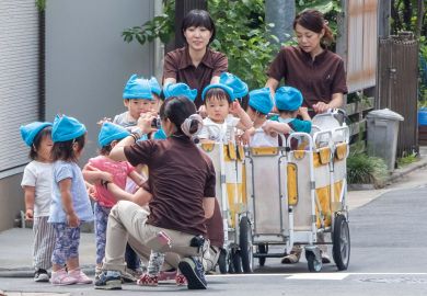 Japanese nursery babies in an outing at Kamimeguro street, Tokyo, Japan to illustrate Tokyo axes tuition fees for large families to boost universities