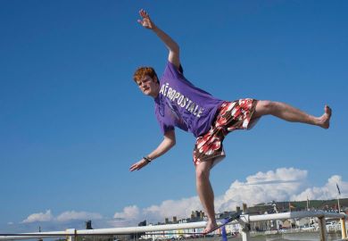 A university college student, on a slack rope balancing to illustrate Business model will ‘soon fail’