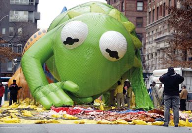 A giant Kermit the Frog balloon with helium is low on the ground at Macy's Thanksgiving Day Parade n New York City to illustrate US debt pact throws campuses back in crisis