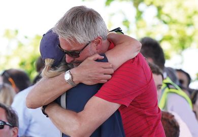  Barnaby Webber's father David embraces Grace O'Malley Kumar's mother ahead of a vigil at the University of Nottingham as the article describes