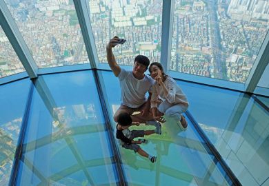 A Korean family taking selfie photo at the glass floor observatory of Lotte World Tower  A Korean family taking selfie photo at the glass floor observatory of Lotte World Tower  for Top Korean universities more ‘glass floor’ than ‘social ladder’