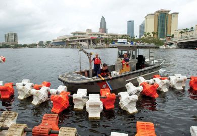 Coast Guards set up "water barriers" to restrict access under bridges near the Tampa Bay to illustrate US set to impose limits on China’s Thousand Talents programme