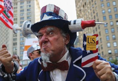 Protestor at "Freedom Rally" to protest the vaccination mandate in New York City Protestor at "Freedom Rally" to protest the vaccination mandate in New York City to illustrate US campuses retreat from vaccine mandates despite Covid surge