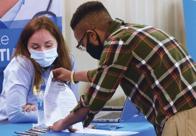 Person at a job fair  Person at a job fair as a metaphor for NIH funds cluster hiring of ethnic minority  scientists