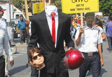 Person dressed headless and holding a dummy head as a metaphor for Indian leadership vacuum raises questions over sector reforms