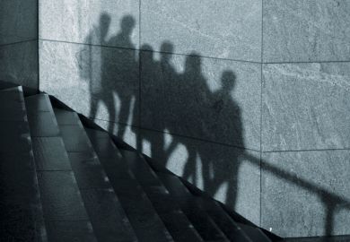 The shadows of anonymous people walking in one direction down stairs are seen on a wall in London as a metaphor for some students abusing privacy allowances