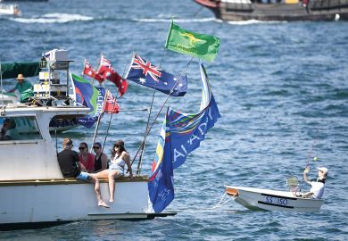 A small boat is being towed on the harbour in Sydney, Australia by a larger boat with people relaxing on board A small boat is being towed on the harbour in Sydney, Australia by a large boat with people relaxing on board to illustrate the pay disparity data reveal elite clique in Australian universities