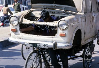 Man transporting car body to illustrate Indian court ruling ‘saves university places’ for upper castes