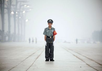 Guard standing in thick fog in China to illustrate Scholars sceptical of China’s new anti-corruption majors