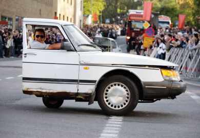 Person giving a performance in half a car
