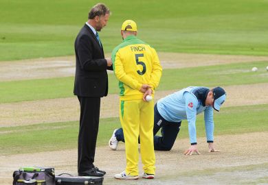 England captain Eoin Morgan inspects the pitch as match referee Chris Broad (l) chats with Australia captain Aaron Finch