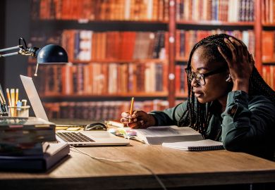 Young woman sitting at table in a library to illustrate My international students make me feel like an academic again