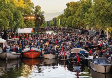 Crowds on boats gather towards a floating stage on the Prinsengracht Crowds on boats gather towards a floating stage on the Prinsengracht to illustrate Dutch plead for limits on international recruitment