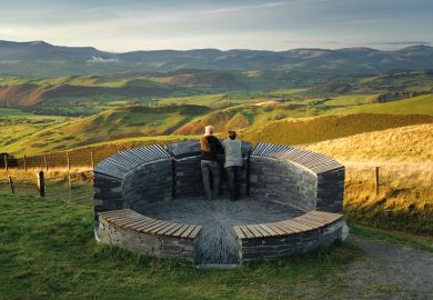 A couple of tourists admiring view of north powys to illustrate Welsh tertiary regulator ‘could be model for England’